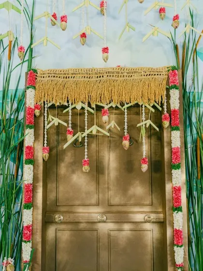 A closer view of the centerpiece door, adorned with a straw valance and delicate floral hangings. This setup is a perfect example of simple, elegant, and customized event design.