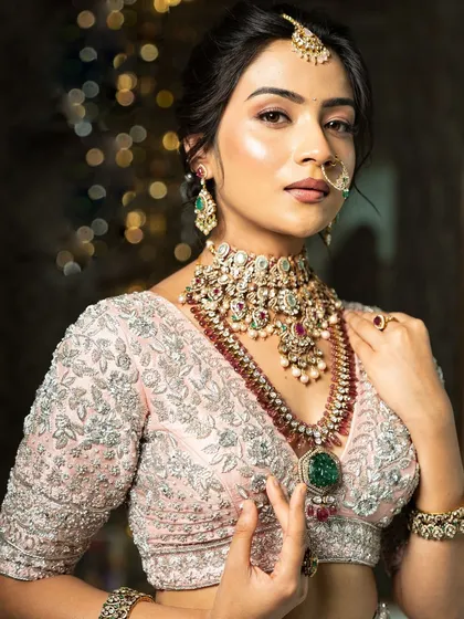 Twirl into a fairytale with this baby pink bridal lehenga. I designed it with intricate horse embroidery on the raw silk skirt and paired it with a heavily handworked blouse and a delicate net dupatta for a truly heavenly look.