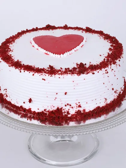 Our classic red velvet cake gets a romantic touch with a simple heart design on top. The iconic red sponge and cream cheese frosting are sprinkled with red velvet crumbs for a beautiful finish.