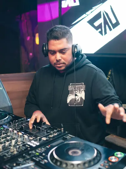 At the helm at Flamiingo Lounge, with my logo on the screen behind me. I bring a professional brand and top-tier equipment to every venue.