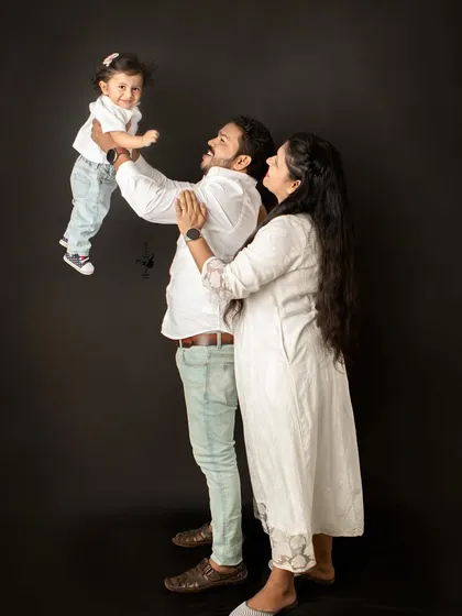 A beautiful family moment filled with pure happiness. The simple joy of a father lifting his child into the air is a memory I feel honored to capture against a classic studio backdrop.