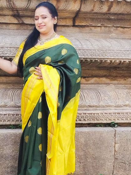 The rich butti work on the green body of the saree adds to its antique charm.