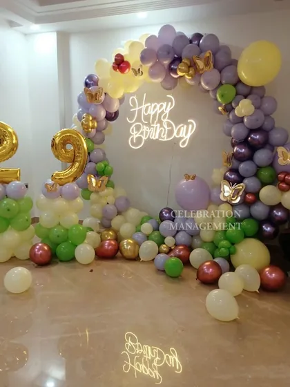 This shot highlights the details in the balloon arch, including the smaller balloon clusters and the placement of the golden butterflies that tie the theme together.