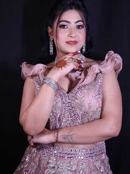 A close-up portrait focusing on the ruffled shoulder detail and the elegant American diamond necklace and earrings.