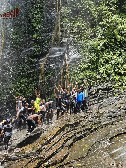 A group celebrating together under the Hidlumane waterfalls on the Kodachadri trek.