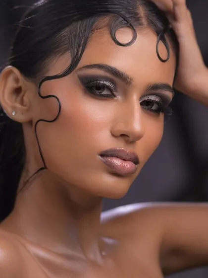 In my editorial module, you will learn to push creative boundaries. This look focuses on advanced techniques like creating a sculpted wet-look hairstyle and a dramatic, glossy smokey eye that's ready for a magazine cover.