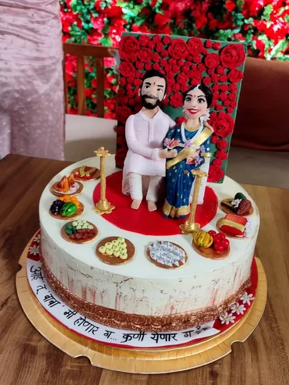 A cake that tells a story. This incredible custom cake features the parents-to-be in their traditional attire, showing the beautiful personalization that makes a baby shower so special.