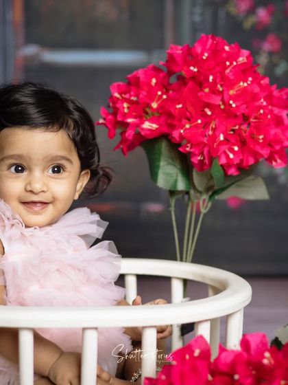 This little girl's sweet smile lights up the frame in this beautiful milestone portrait.