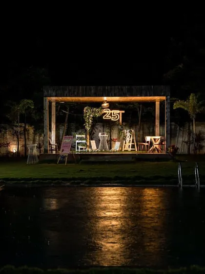 An intimate 25th birthday celebration set against a rustic poolside backdrop. The warm lighting reflecting on the water, combined with personalized decor and lush florals, created a romantic and truly special ambiance for this milestone evening.