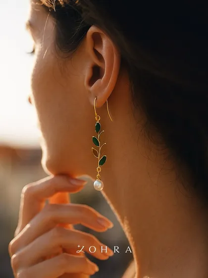 Jewellery should feel like a memory you can wear. These nature-inspired earrings were designed to capture a feeling of delicate grace, with emerald leaves cascading down to a single, luminous pearl. I love creating pieces that connect with your personal story and identity.