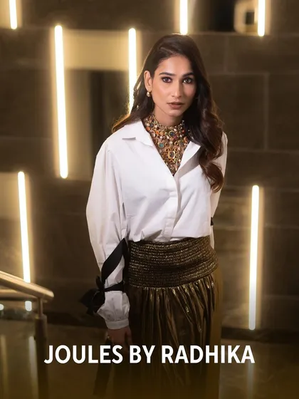 The stylish Aneri Vajani pairs a classic white shirt with our bold, multi-gemstone navratan-style necklace for a stunning fusion look.