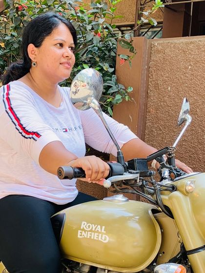 A close-up of a happy rider. The confidence gained from our training shines through as she sits comfortably in control of her Royal Enfield.