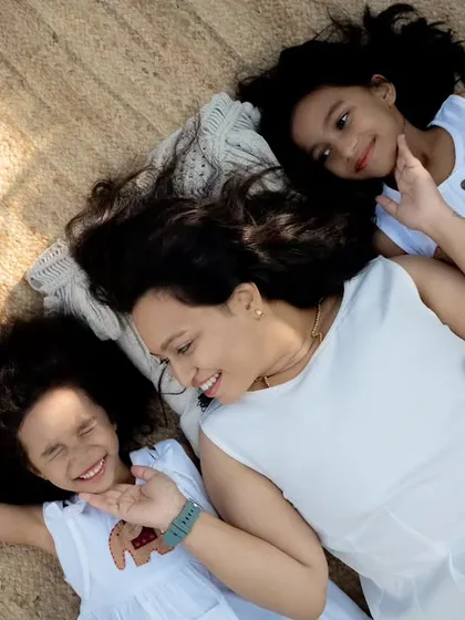 A playful, candid moment from above, showing a mother and her daughters laughing together. This is the kind of unscripted joy I love to photograph.