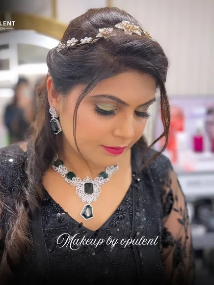 We love creating a little drama. This look features a striking green smokey eye, a sculpted half-updo with a delicate hair accessory, and a nude lip to balance the look, making it perfect for an evening reception or cocktail party.