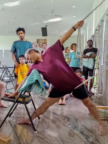 Another view of the supported triangle pose demonstration, showing the focused attention of the students during a workshop.