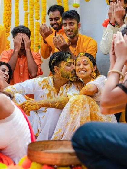 A candid moment of friends and family sharing a laugh during a fun-filled Haldi. We capture the reactions of everyone involved, not just the couple.
