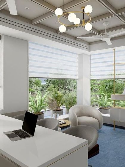 A design concept for an MD cabin surrounded by lush greenery. The space is designed to feel open and connected to the outdoors, with a calm blue carpet and light, modern furniture.