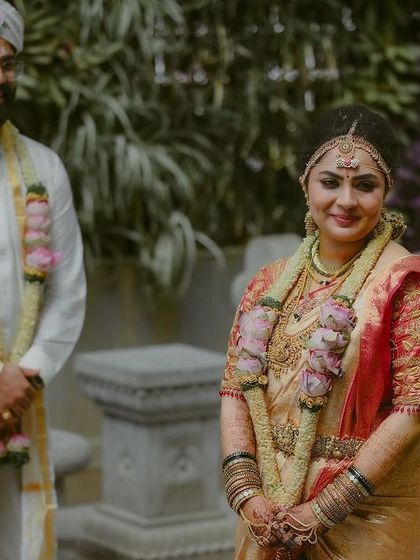 A beautiful moment of a groom looking at his bride. Her smile and traditional attire create a perfect portrait of a South Indian wedding day.