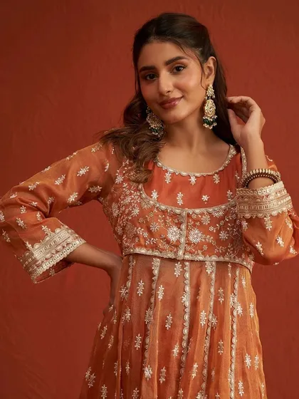 A close up of this beautiful orange anarkali, perfect for a mehendi ceremony. The delicate embroidery and gota patti work are exquisite.