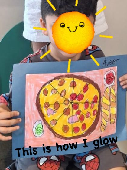 The best part of the process: the glow of accomplishment. This young student proudly displays his completed pizza drawing, a testament to his focus and new skills.