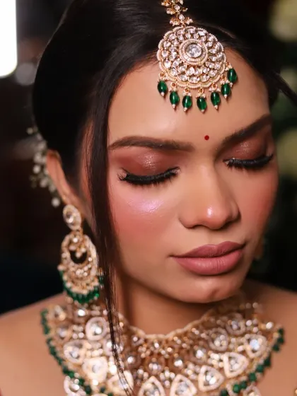 An elegant and royal bride look. This close-up focuses on the soft, shimmery eye makeup and the perfectly defined brows.