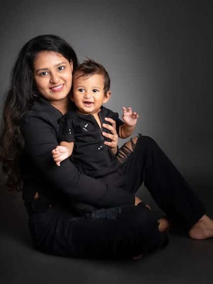 Twinning in black! This mother and son portrait against a simple dark backdrop is so stylish and sweet. Their smiles truly light up the photo.