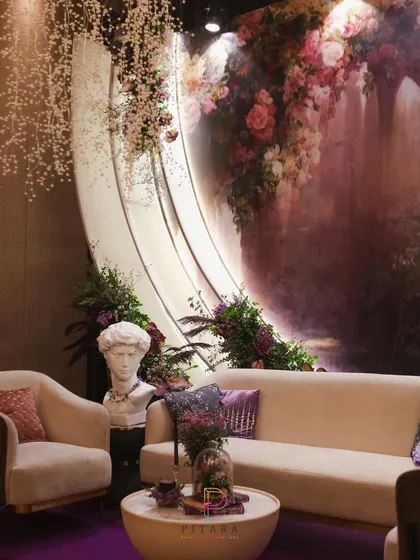 Another angle of the artful lounge, showing the interplay between the classical bust, the modern furniture, and the romantic, painterly backdrop.