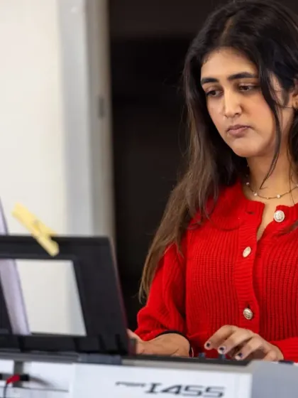 A student focuses intently on her keyboard part during a live performance. These events provide invaluable real world experience for our young musicians, teaching them focus and professionalism.