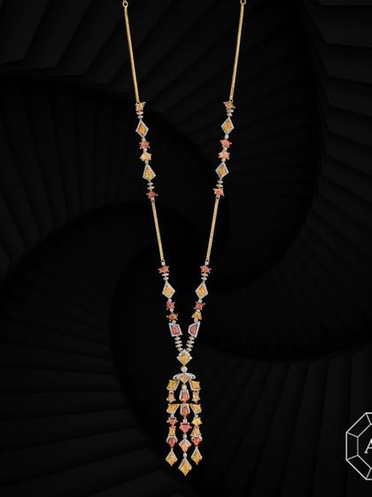 This elegant 18k gold lariat necklace is adorned with vibrant multi-cut sapphires and delicate round diamond accents.