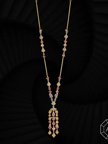 This elegant 18k gold lariat necklace is adorned with vibrant multi-cut sapphires and delicate round diamond accents.