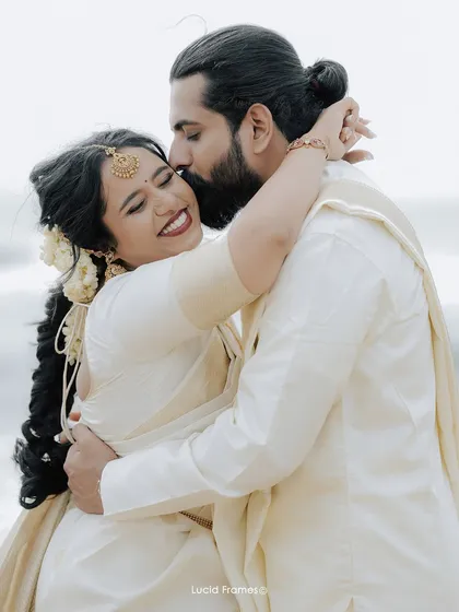 A heartfelt kiss on the forehead, a tender moment from a beautiful beachside wedding in Kerala. We focus on capturing these emotional connections.