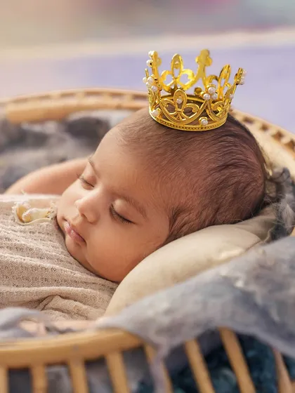 A close up on the little prince. The tiny, detailed crown is the perfect accessory for this royal-themed newborn shot.