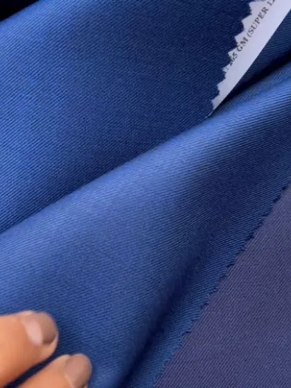 A vibrant blue Super 120's wool fabric, offering a soft hand-feel and excellent drape for a luxury suit.