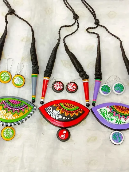 A collection of my eye-shaped pendants, which combine mandala and alpona art. This image shows the variety of colors available.