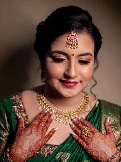 Admiring her final look, this client looks absolutely beautiful. The soft, blended eyeshadow and radiant skin create a sophisticated and elegant makeup style for her engagement ceremony.