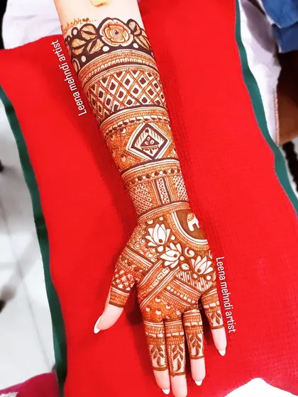 A full-arm design with a beautiful flow and a rich henna stain.