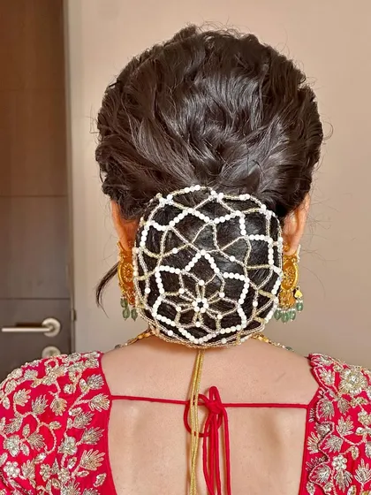 A direct back view of this unique pearl net bun. The texture in the bun itself adds dimension, while the net provides a beautiful, intricate covering.