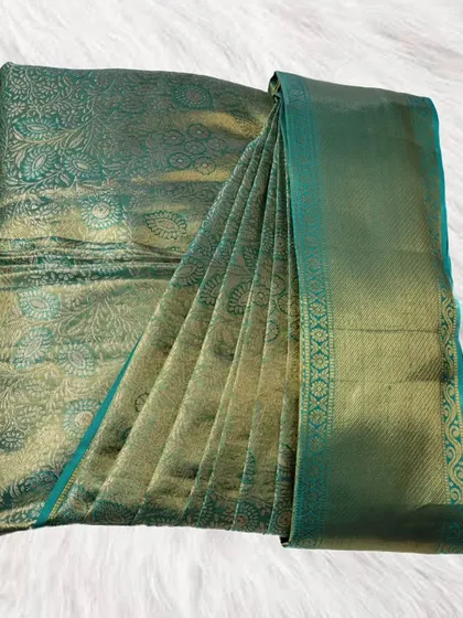 This stunning green silk saree with a detailed pattern is neatly pleated and boxed. It's a practical solution for keeping your valuable silks safe and ready for any event.