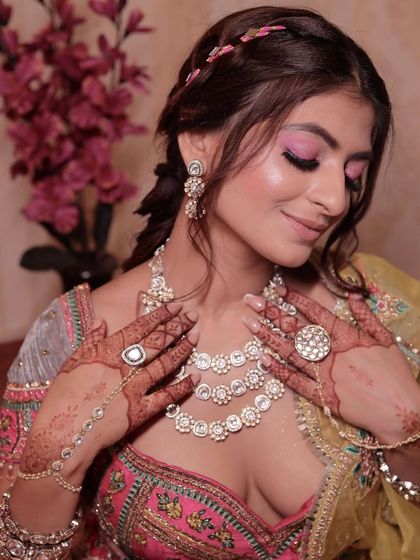 Neon magic on the eyes. This look features a bright pink eyeshadow blended out for a soft, dreamy effect, paired with a beautiful, intricate hairstyle.