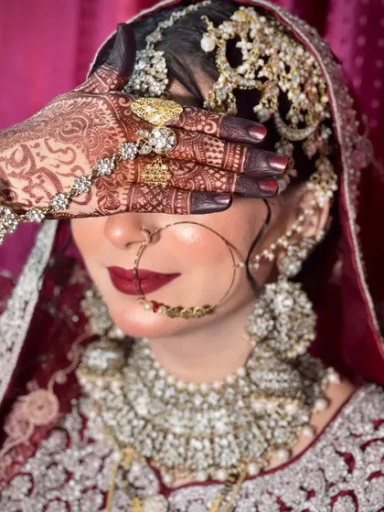 The henna, the jewellery, the makeup. It all comes together to create the bride. I love this shot because it captures the rich details, from the deep red lips to the heavy silver and maroon jewellery.