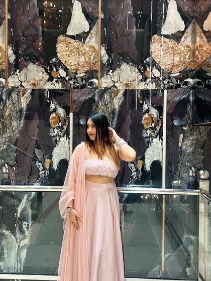 A final look at the pretty pink lehenga. The mirrored background adds a touch of modern glamour to the traditional outfit.