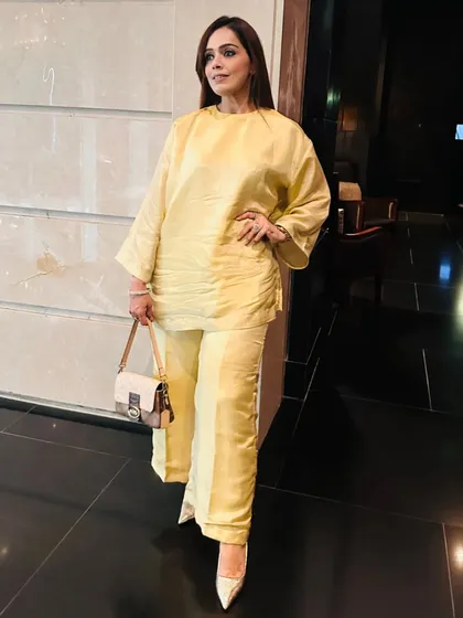 This elegant yellow choga set is a perfect example of minimalist ethnic charm. Its loose, flowing fit is incredibly comfortable, making it ideal for a daytime festive event or puja.