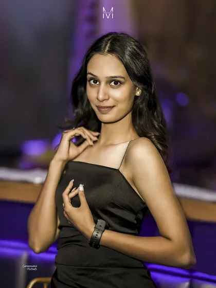 A duplicate of image 197, this portrait captures a sweet and engaging moment with a gentle smile in the cool club lighting.