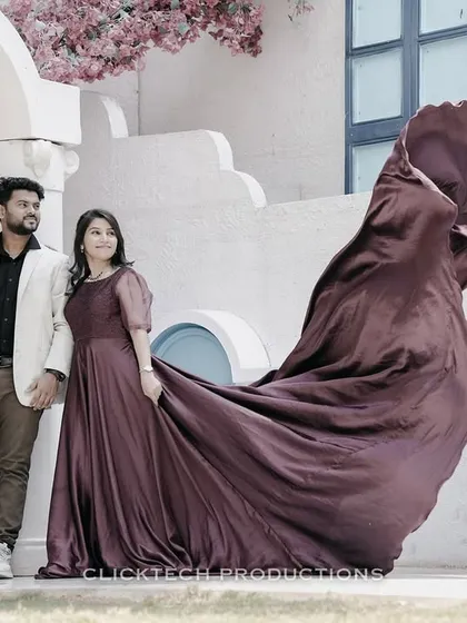 A couple poses against a Santorini-inspired white and blue backdrop, with the bride's flowing gown adding a touch of drama. This shows how we can create different world themes right here in Bangalore.