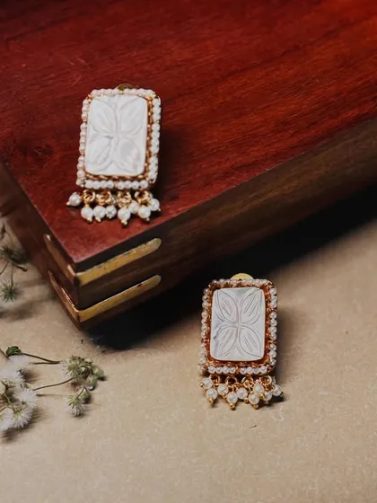 Unique and chic. These rectangular earrings feature carved mother-of-pearl and a delicate pearl border, perfect for a contemporary look.