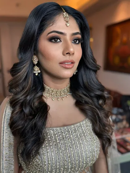 A close-up of this bridesmaid's glam. The smokey eye is blended to perfection, and the skin is glowing, making her look and feel like a star.