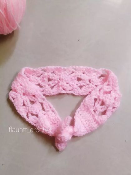 The Candyline Summer Headband shown on its own. The lacy, knotted design is both beautiful and practical for keeping hair out of little faces.