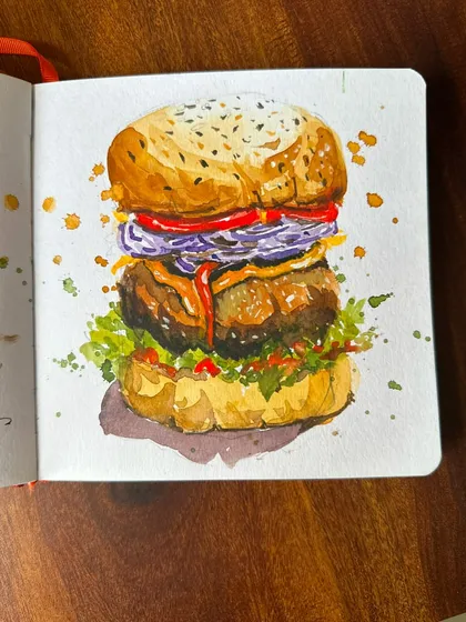 A juicy, detailed watercolour painting of a burger, showcasing my ability to paint food with texture and vibrant colour.