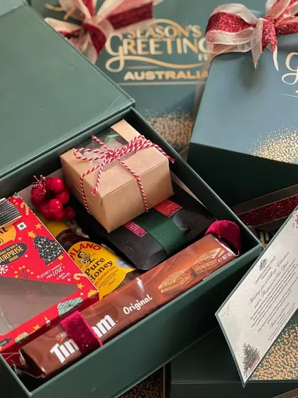 A look inside the Australian Consulate's Christmas hamper. It included a mix of Australian treats like Tim Tams and local festive items like plum cake and honey.