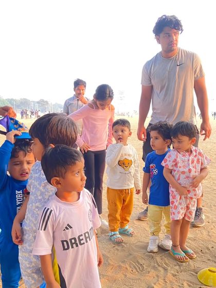 A group of toddlers listening intently to instructions. Even our youngest athletes are captivated by the fun and games we have planned on the beach.